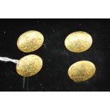 A PAIR OF OVAL 18CT GOLD CUFFLINKS with chased decoration to fronts and backs