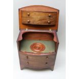 A 19TH CENTURY BOW FRONTED COMMODE with imitation four-drawer frontage, having typical lift-up lid