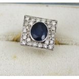 AN 18CT GOLD ART DECO STYLE SAPPHIRE AND DIAMOND RING, the central oval sapphire set within a square