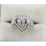 AN 18k WHITE GOLD HEART FORM RING set with diamonds, ring size N