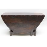 AN 18TH CENTURY OAK FINISHED TWIN-FLAP GATELEG TABLE with planked oval top, supported on turned