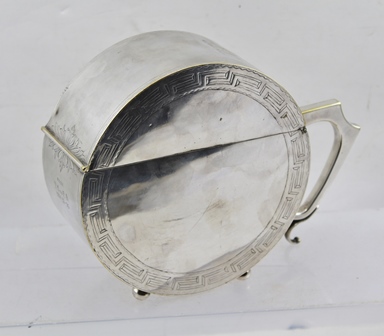 A LATE 19TH CENTURY ANGLO INDIAN SILVER PLATED TEA CADDY of circular form with hinged lid, the