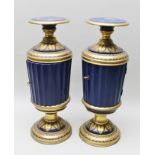 A PAIR OF 20TH CENTURY PAINTED AND GILT WOOD JARDINIERE STANDS, having fitted cupboards to the body,