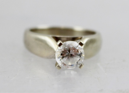 A WHITE GOLD SOLITAIRE CUBIC ZIRCONIA LADY'S RING, stamped 10k, ring size N and half