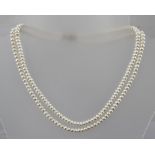 A TWO STRAND PEARL NECKLACE of uniform pearls, with 9ct gold clasp