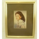 SOPHIA LOREN (1934 - ) An autographed colour studio portrait, in brass effect frame, mounted and