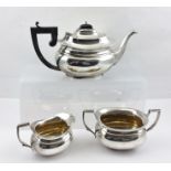 A GEORGIAN DESIGN THREE-PIECE SILVER TEA SET, comprising teapot, milk jug and a two-handled sugar