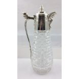 AN EDWARDIAN CUT GLASS CLARET JUG, the silver plated top with hinged cover, having winged creature