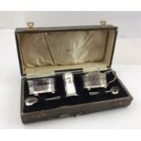 BARKER BROTHERS A GEORGIAN DESIGN THREE-PIECE SILVER CONDIMENT SET, comprising mustard, pepper pot