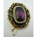 A VICTORIAN MOURNING JEWELLERY BROOCH, set with central facet cut amethyst colour gem surrounded