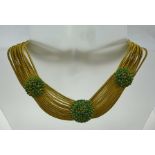 NINA RICCI OF PARIS A DESIGNER COSTUME CHOKER NECKLACE, having gilded rope strands set with roundels