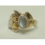 AN ART NOUVEAU DESIGN GOLD MOUNTED SILVER AND MOONSTONE SET RING, size L and half