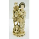 AN EARLY 20TH CENTURY JAPANESE IVORY OKIMONO, depicts a Bijin with three monkeys, ink filled scratch