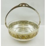 A WMF STYLE SILVER PLATED FRUIT BASKET with original glass liner, 21.5cm diameter