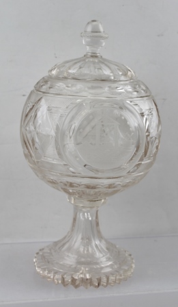 A 19TH CENTURY CUT GLASS STEMMED BOWL with cover, having three engraved roundels to the body, to