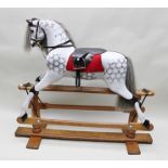 A "LINES BROTHERS LTD" ROCKING HORSE, dapple grey painted with restored mane and tail and leather