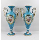 A PAIR OF EARLY 20TH CENTURY FRENCH PORCELAIN VASES, of slender baluster form with gilded swan