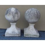 A PAIR OF RECONSTITUTED STONE BALL FORM FINIALS for a gateway entrance, on squared bases, overall