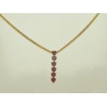 A GARNET PENDANT set five heart shaped vertical stones in a 9k gold mount on a 9ct gold chain,
