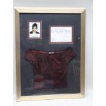 A FRAMED ITEM OF CLOTHING WORN BY A 'CORONATION STREET' CHARACTER, GEENA GREGORY, played by Jennifer