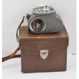 A "G.B. - BELL & HOWELL" 8mm CINE CAMERA, with booklet in leather case