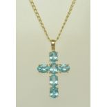 A 9CT GOLD AND BLUE TOPAZ CROSS on chain, cross 3cm x 2cm