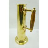 AN EARLY 20TH CENTURY ARTS & CRAFTS STYLE BRASS JUG with wooden handle, 30cm high