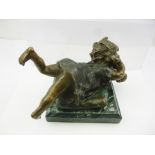 A LATE 20TH CENTURY PATINATED BRONZE, depicting a child lying upon a cushion, mounted upon a