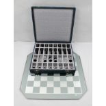 A "SWAROVSKI" SILVER CRYSTAL CHESS SET, king stands 6cm high, cased, together with a mirrored