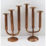 TWO COPPER TABLE CANDELABRA OF ARTS AND CRAFTS DESIGN, each of graduated triple hammered cylinder