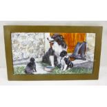 A FRAMED PRINTED TILE depicting a collie dog, pup and a cat, 15cm x 30cm