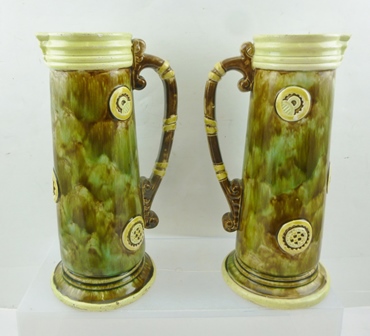 A PAIR OF EARLY 20TH CENTURY MAJOLICA JUGS, tapering cylindrical form, mottled glaze with strap work - Image 2 of 2
