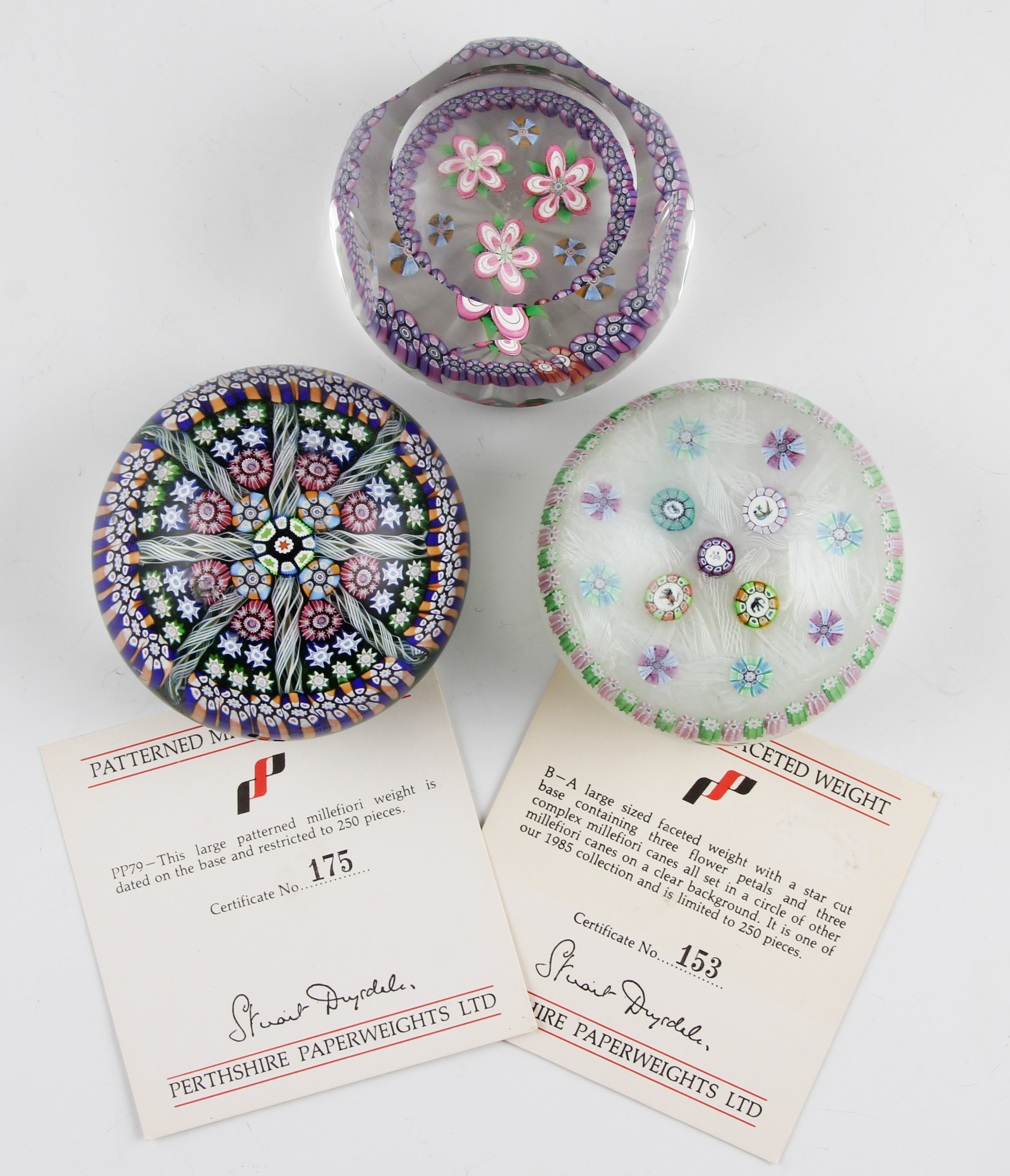 A group of three Perthshire millefiori glass paperweights to include; one having four animal grinder