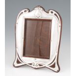 An early 20th Century Walker & Hall silver photograph frame of shield shape with blank cartouche