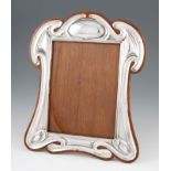 An early 20th Century Art Nouveau shaped silver photograph frame, hallmarked Birmingham 1906 with