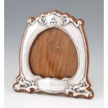 An early 20th Century Art Nouveau silver photograph frame with hammered finish to sides with