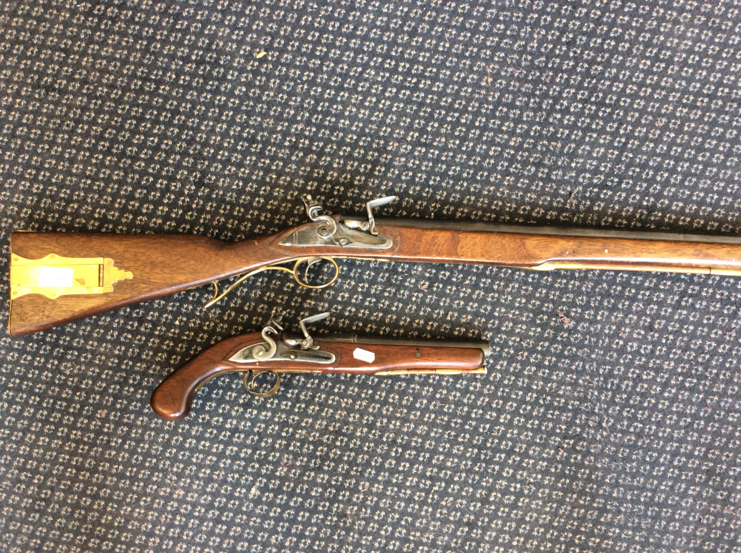 A reproduction flint lock rifle with mahogany stock, together with a reproduction flint lock