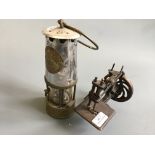 A miners lamp together with Singer miniature sewing machine.