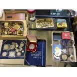 Several boxes of various coins and badges.