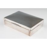 A silver cigarette box, the rectangular form of plain design, the wooden interior with partitions,