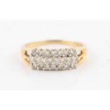 An 18ct yellow gold diamond ring, set with three rows of round brilliant cut diamonds, with split