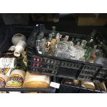 Three boxes of various salt glazed jars and glass bottles.