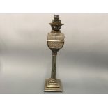 A silver plated converted oil lamp with column decorated base.