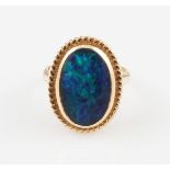 A 9ct yellow gold black opal doublet ring, set with an oval black opal doublet cabochon, measuring