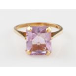 A 9ct yellow gold amethyst dress ring, set with a rectangular cut amethyst, measuring approx.