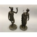 Two bronze female Grecian statues on marble bases.