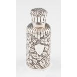 A Victorian silver scent bottle, body of cylindrical form with floral repousse design with blank