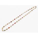 A multi-gemstone necklet, bezel set with oval cut gemstones to include garnets, amethyst, smoky