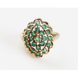 A 9ct yellow gold emerald cluster ring, set with round cut emeralds to an open metalwork head,