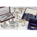 A collection of hallmarked silver items, to include a pill box, a rattle, a pair of weighted dwarf